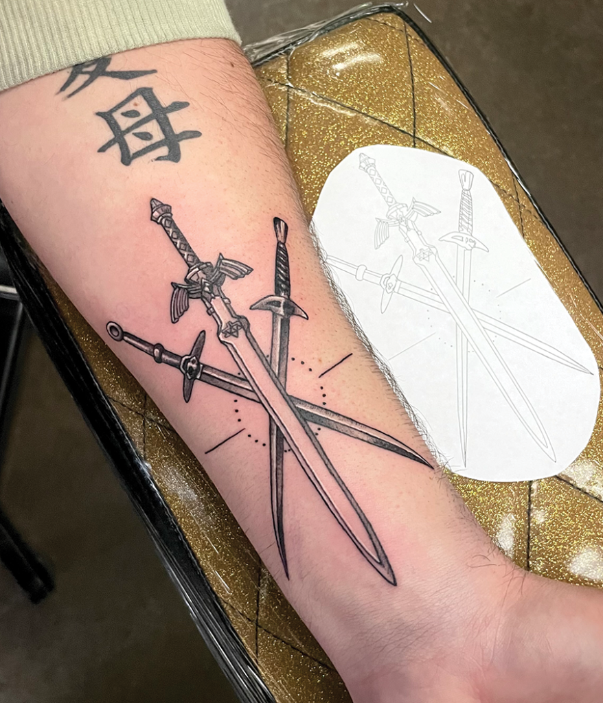 three swords tattoo on arm