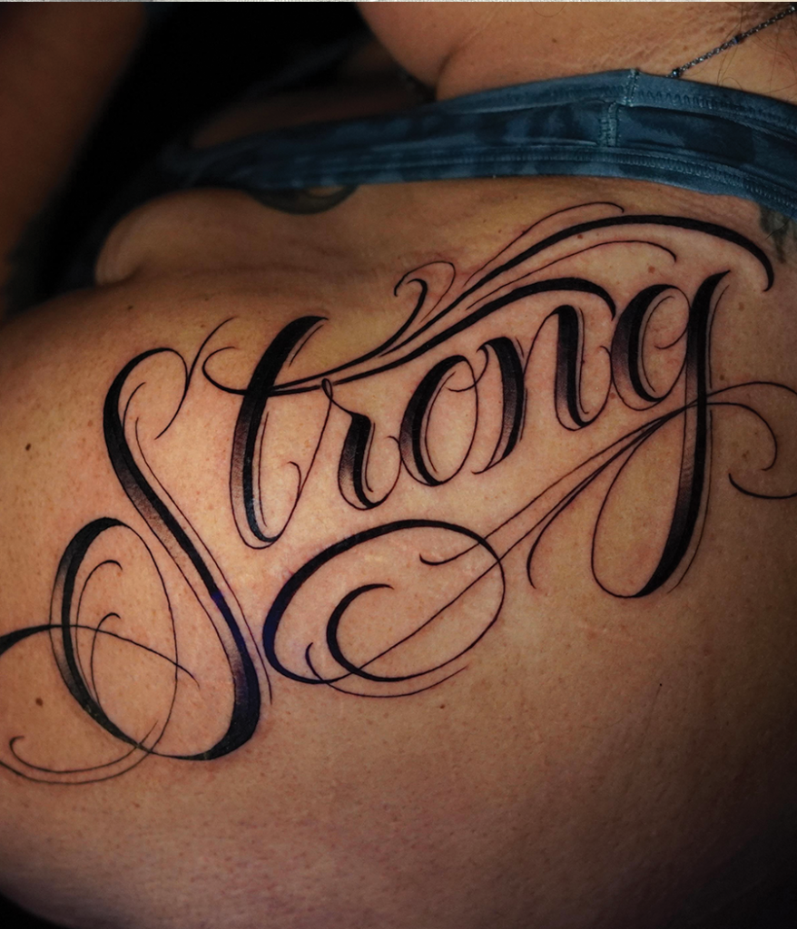 Script tattoo on shoulder