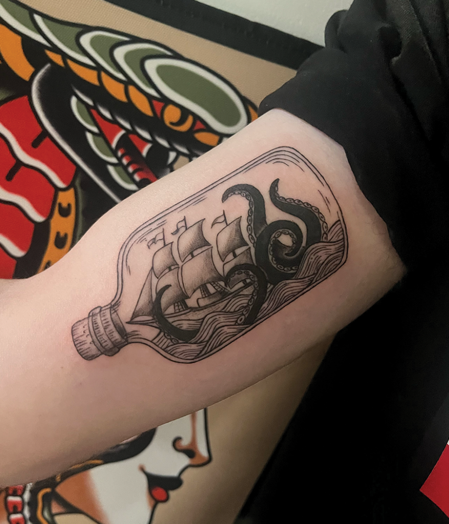 ship in a bottle tattoo on arm