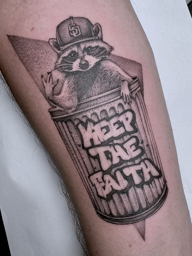 raccoon in trashcan tattoo on arm