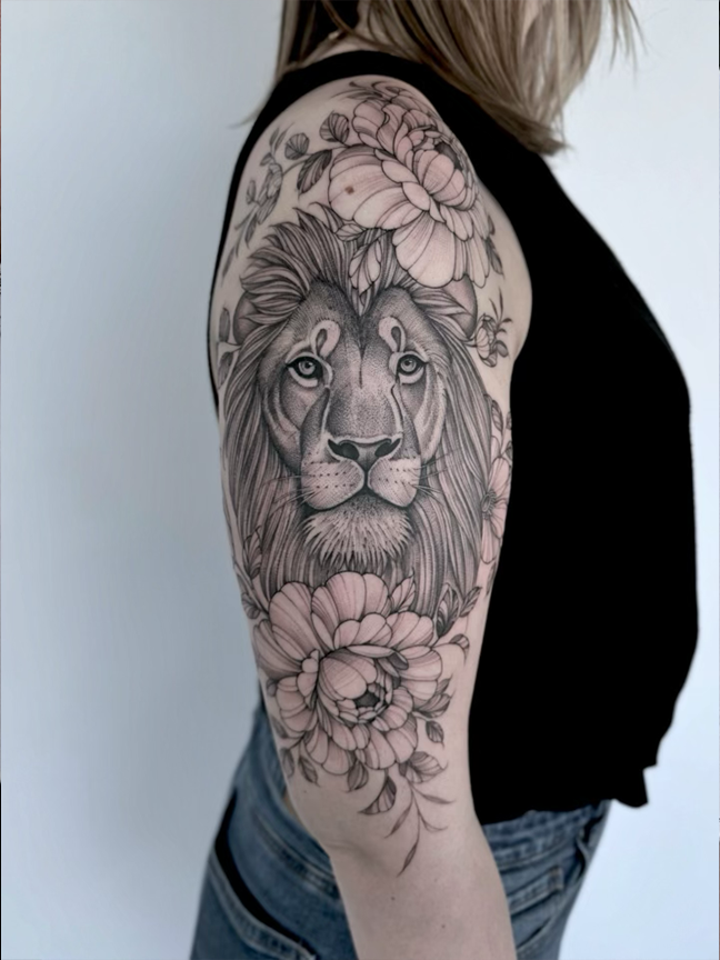 lion and flowers tattoo on arm