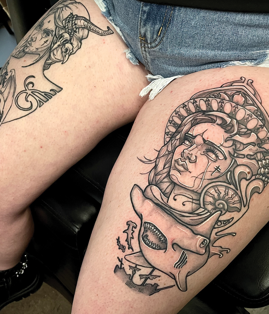 shark and portrait tattoo on leg