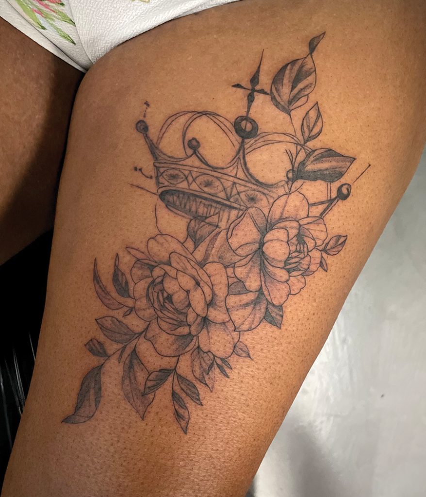 crown and roses tattoo on leg