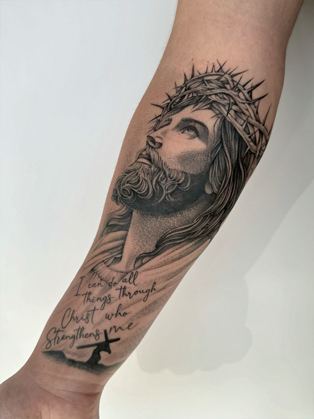religious portrait tattoo on arm