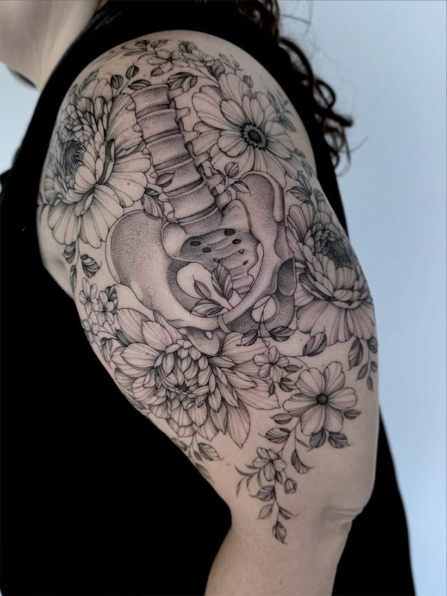 pelvis and flowers tattoo on arm
