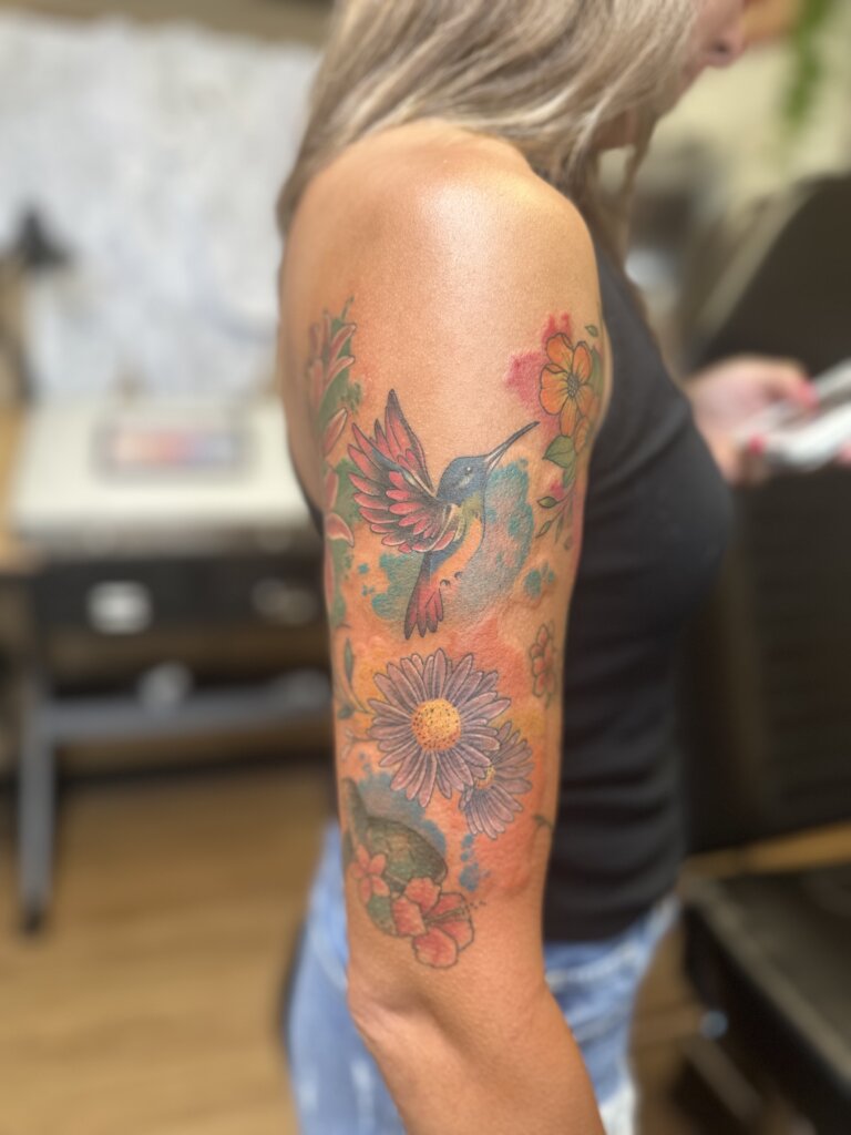 colorful hummingbird tattoo on arm