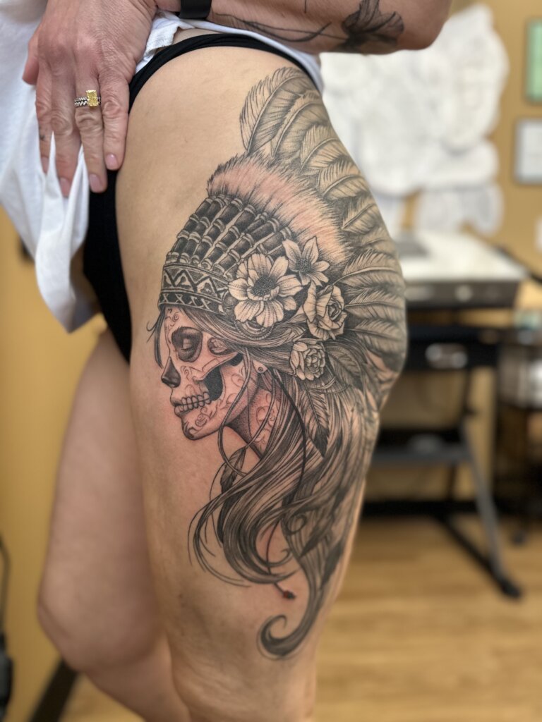 headdress with skull tattoo on hip