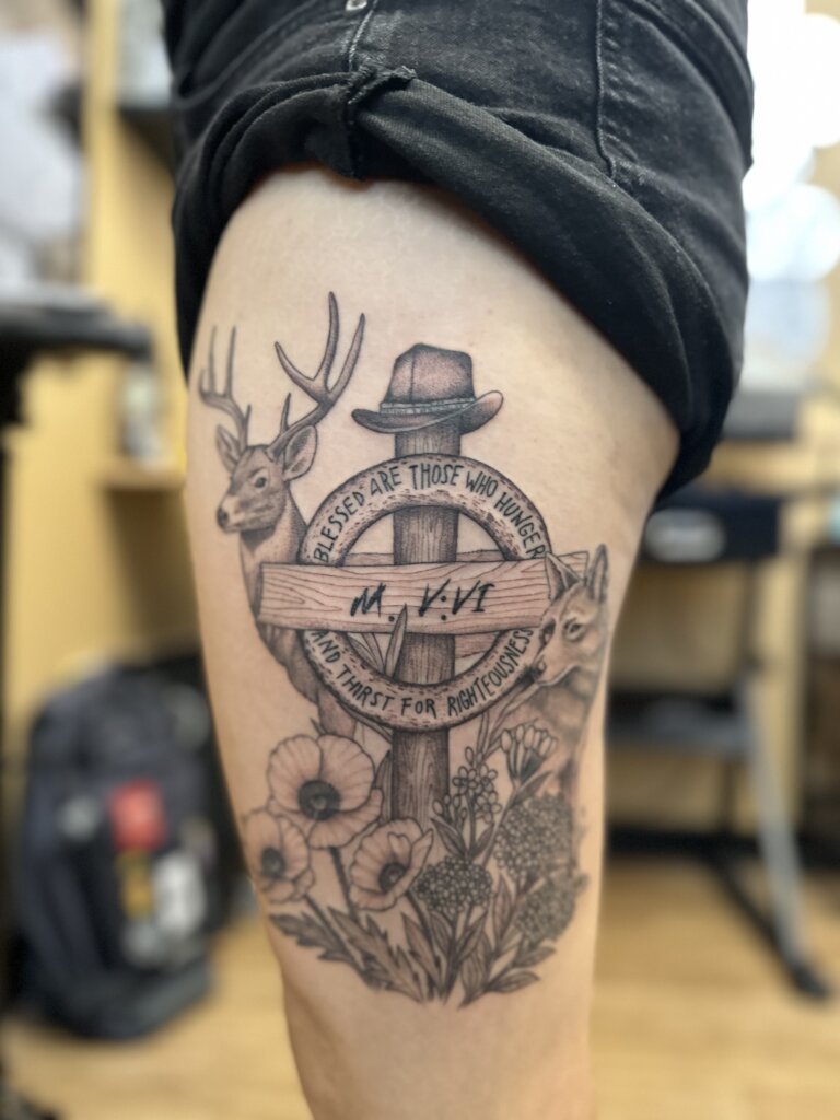 deer and cross tattoo on thigh