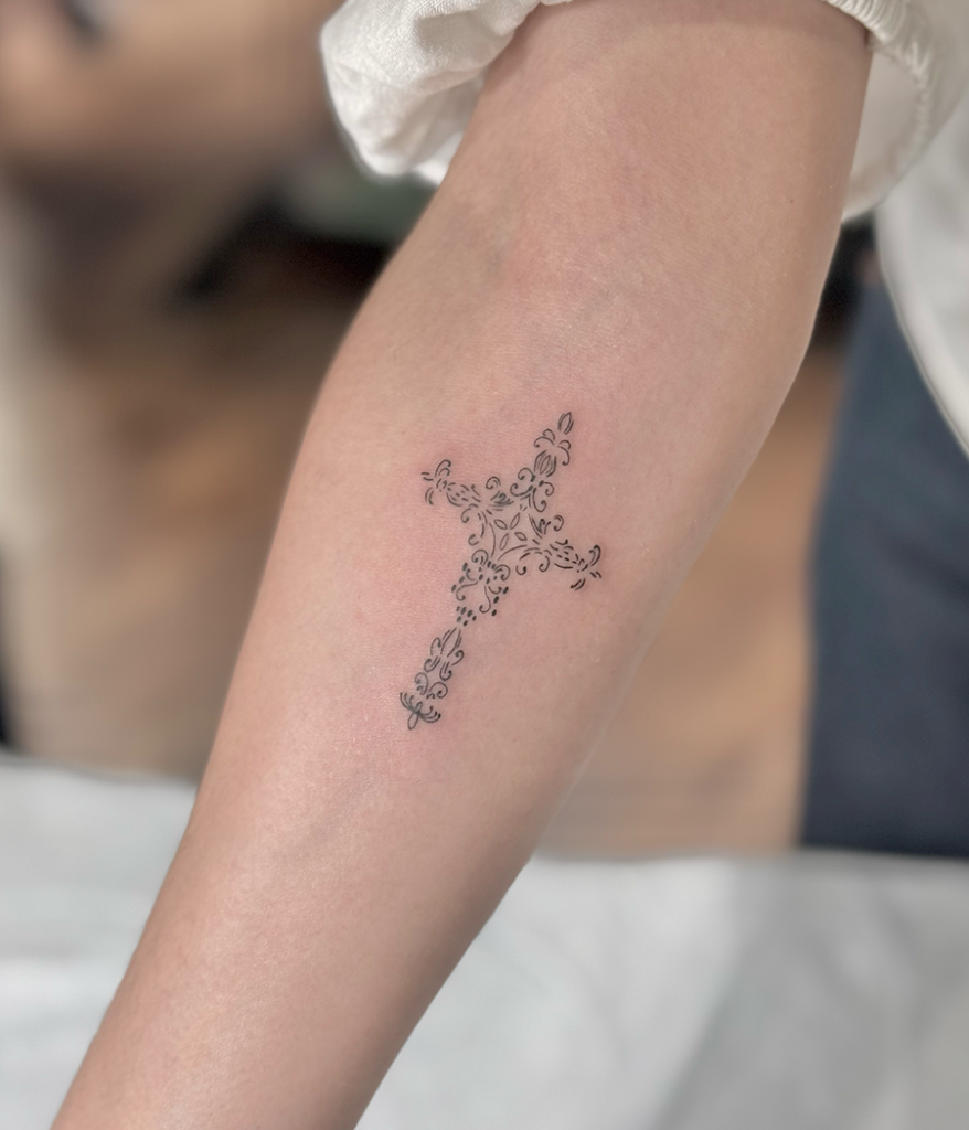 cross tattoo on arm
