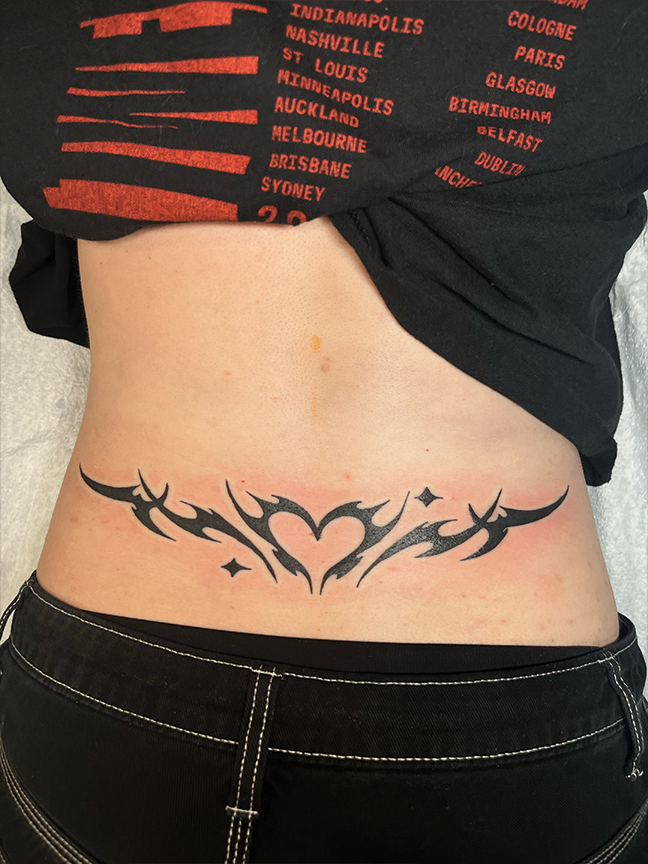 Black heart tattoo on bacl