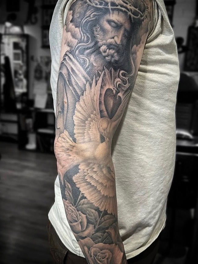 religious figure tattoo on arm