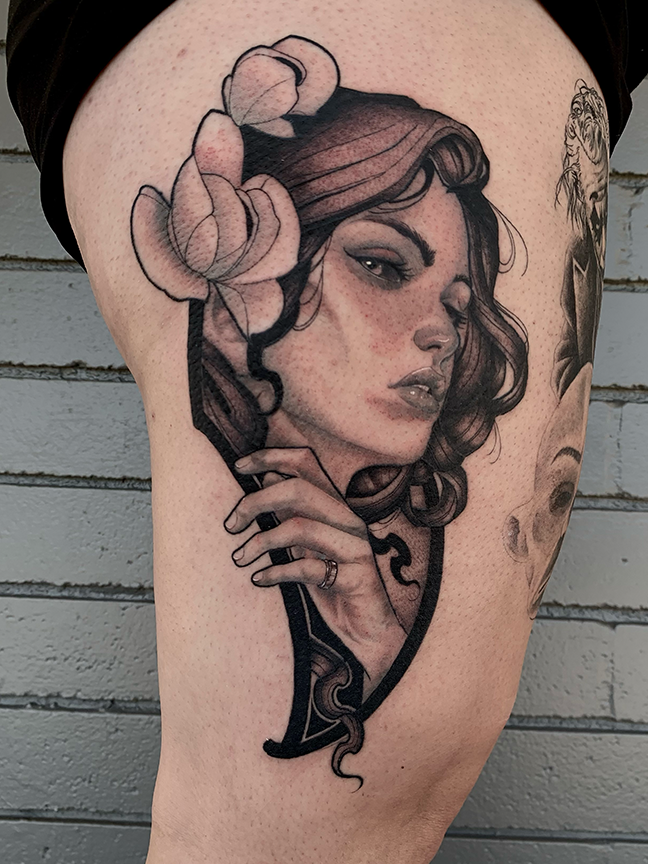 female portrait tattoo on leg