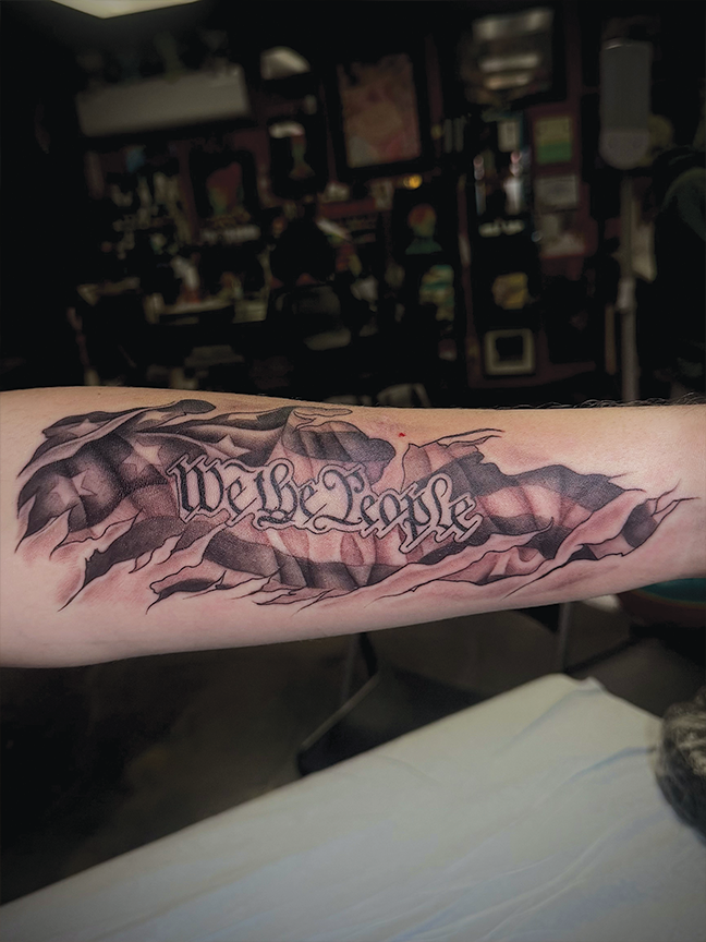 script we the people tattoo on arm
