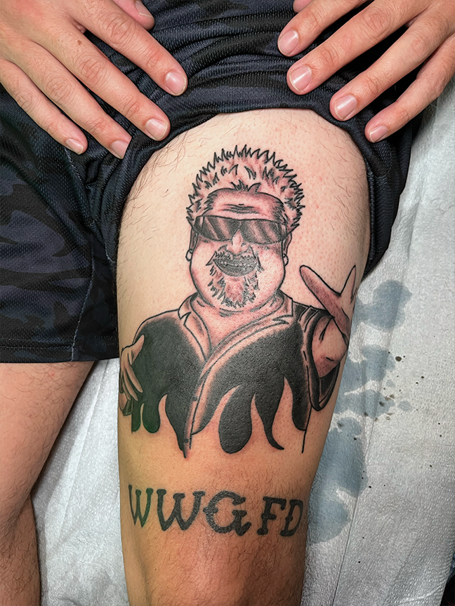 male character tattoo on leg
