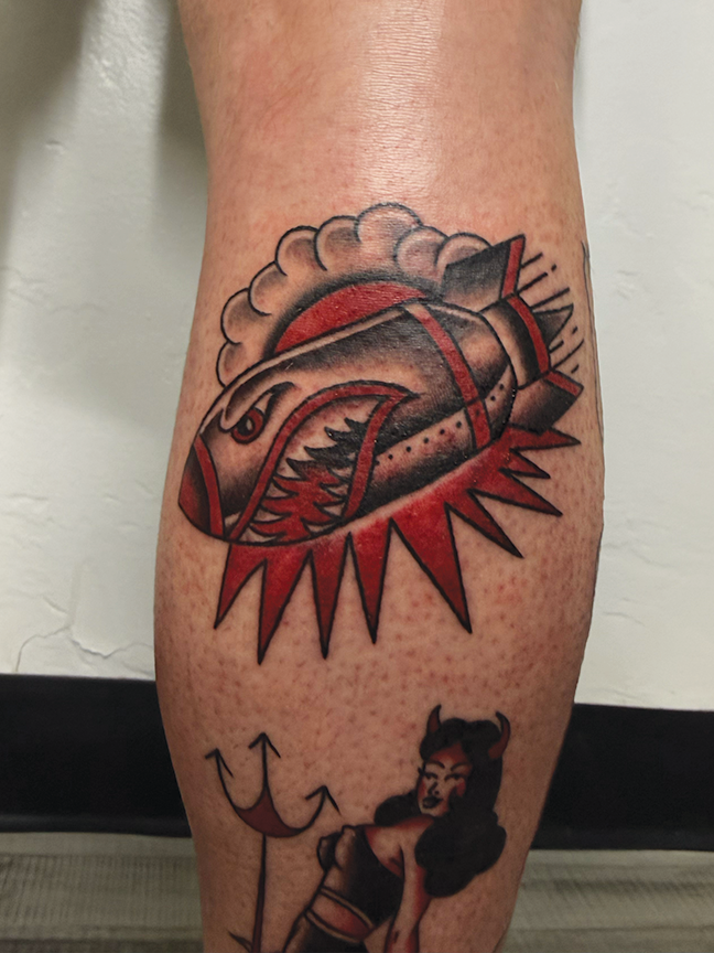 Cartoon bomb tattoo on leg