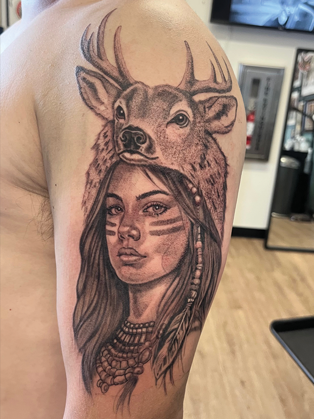Deer and woman portrait tattoo on arm