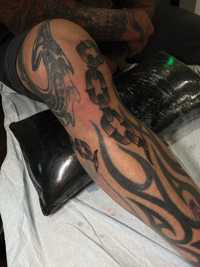 chain tattoo on leg