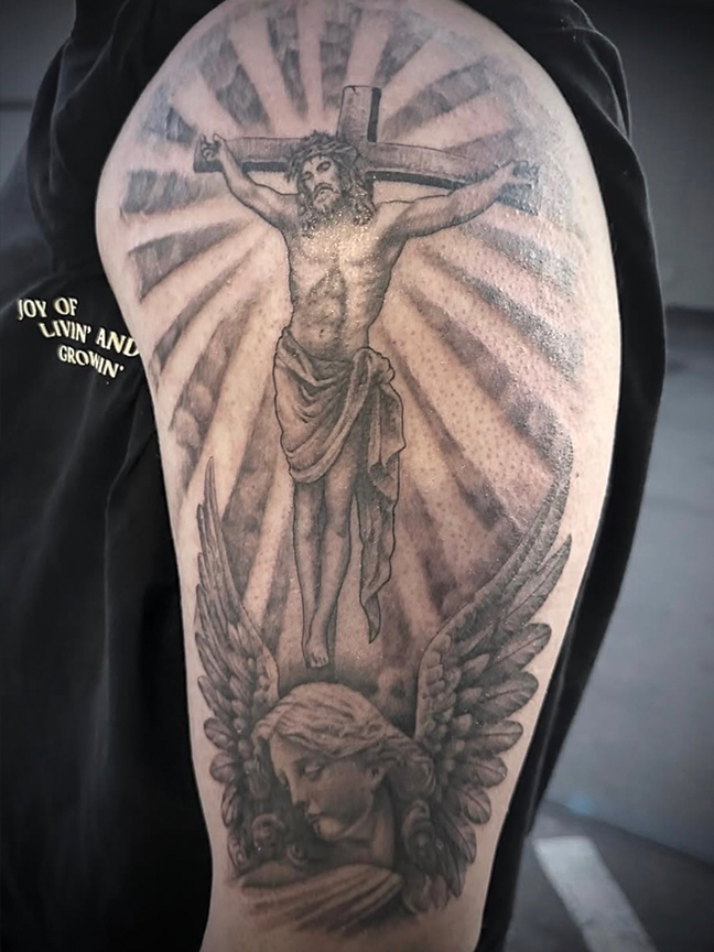 crucifixion tattoo on arm