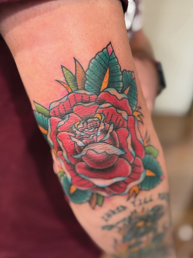 rose tattoo on elbow
