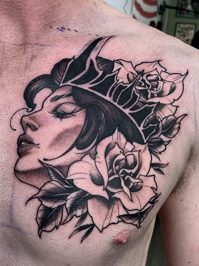 side profile portrait with flowers tattoo on chest