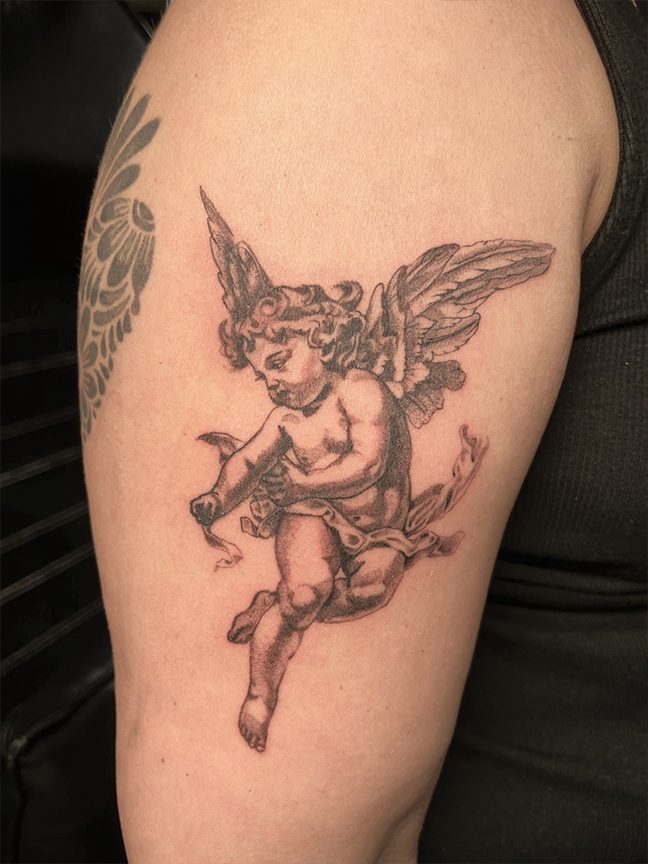 Fine line cherub tattoo on arm