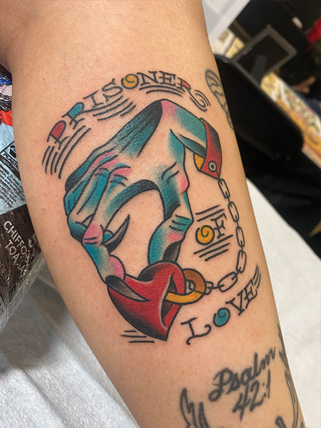 hand and heart tattoo on leg