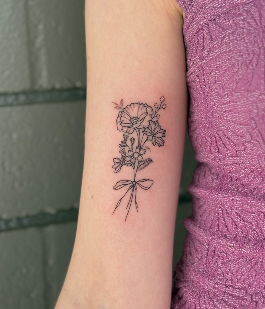 fine line flower tattoo on arm