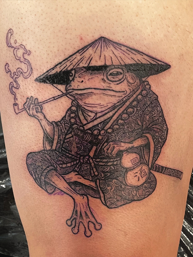 Cartoon samurai frog tattoo on arm