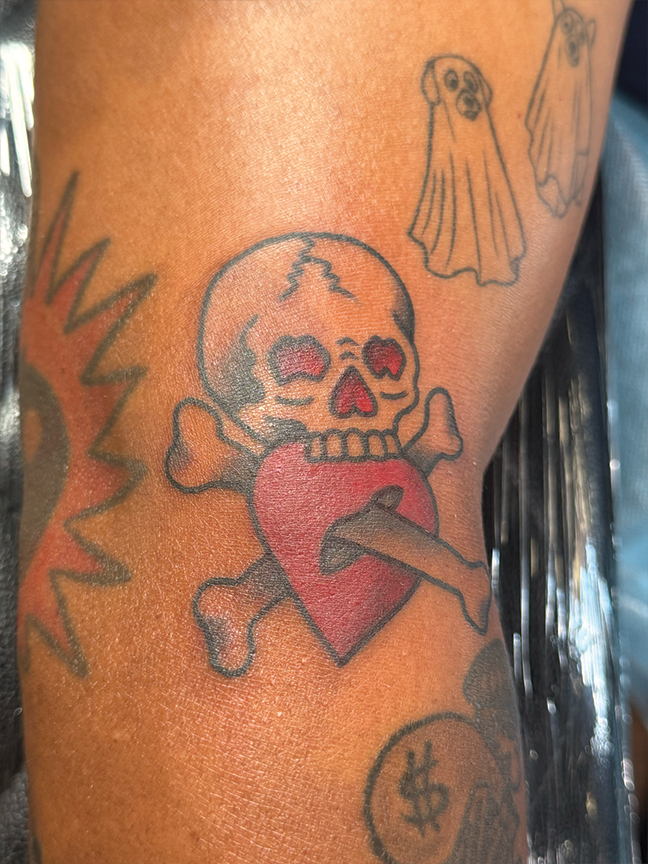skull and heart tattoo on elbow
