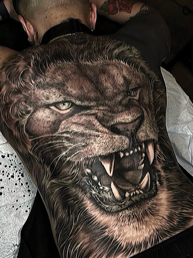 roaring lion tattoo on back