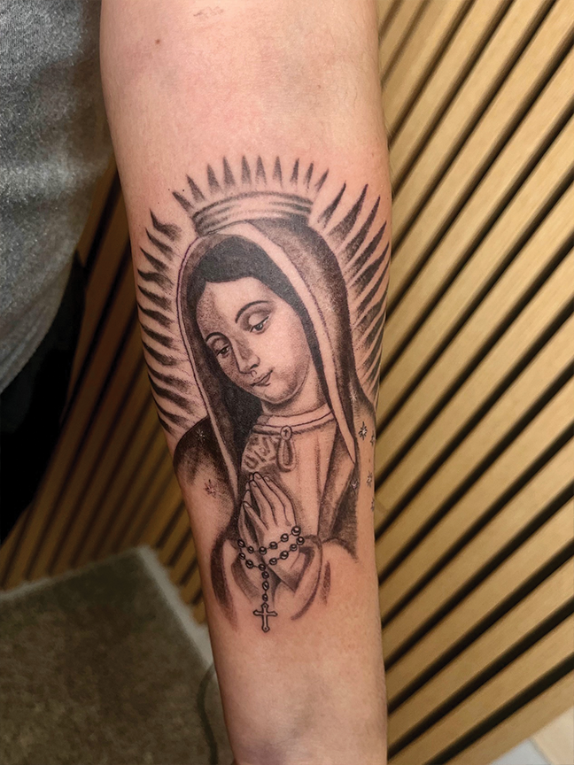 Religious portrait tattoo on arm