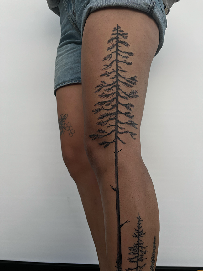 pine tree tattoo on leg