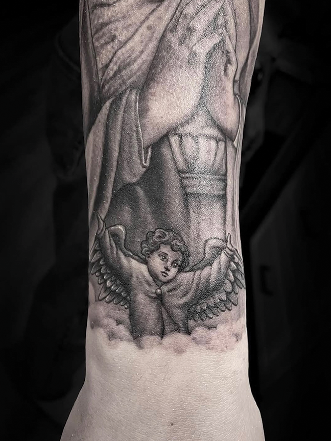 cherub tattoo on arm
