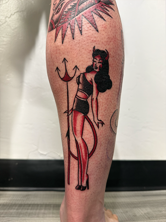 pin up devil lady tattoo on leg