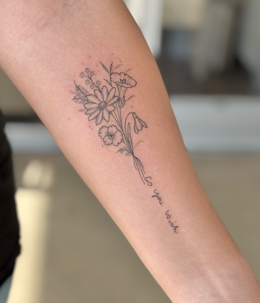 flowers and script tattoo on arm