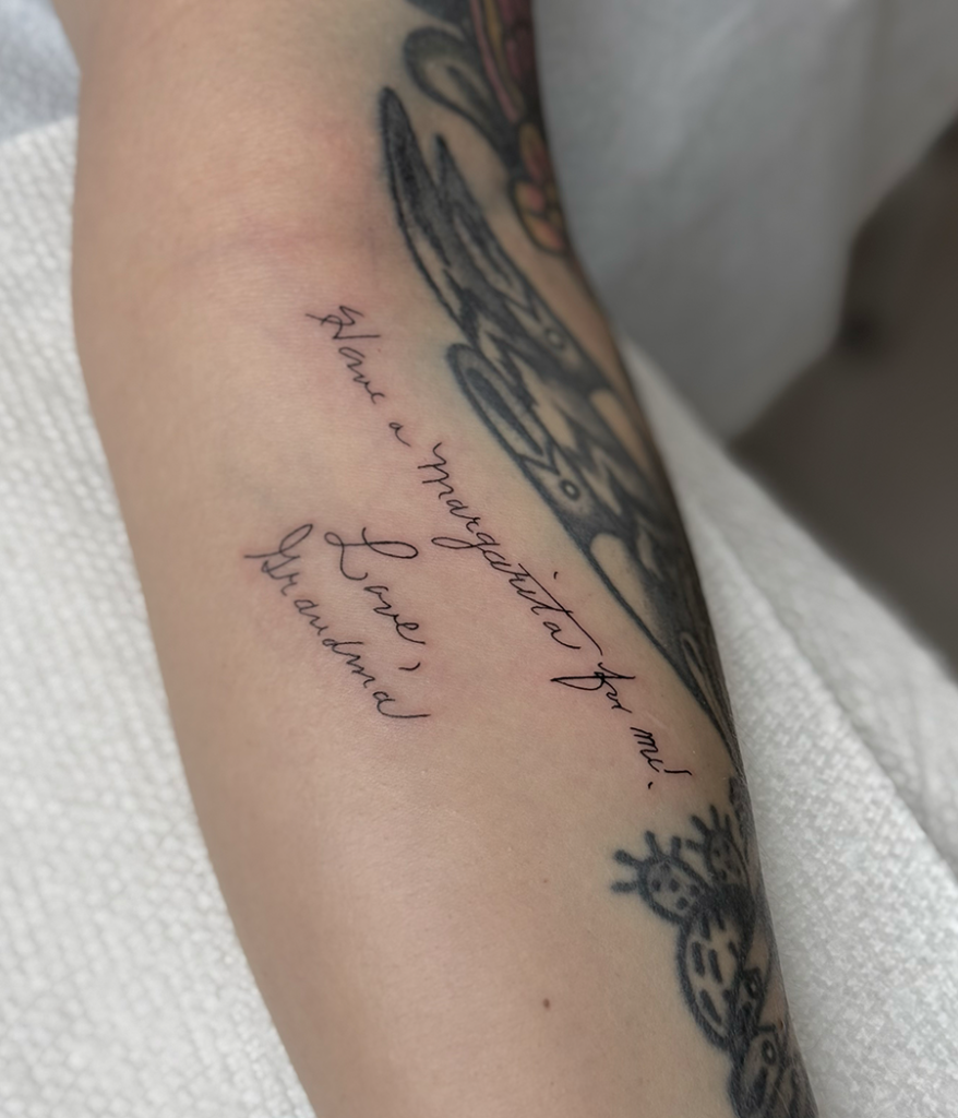 handwritten note tattoo on arm