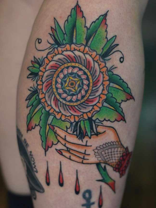 hand holding flower tattoo