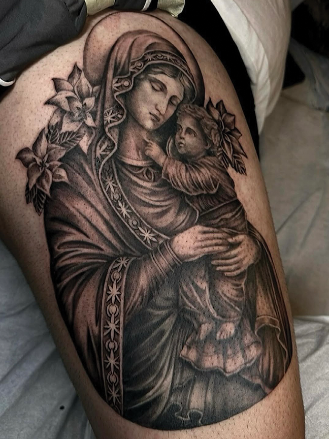 religious portrait tattoo on leg