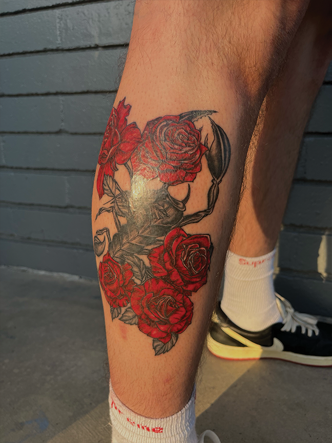scorpion and roses tattoo on leg