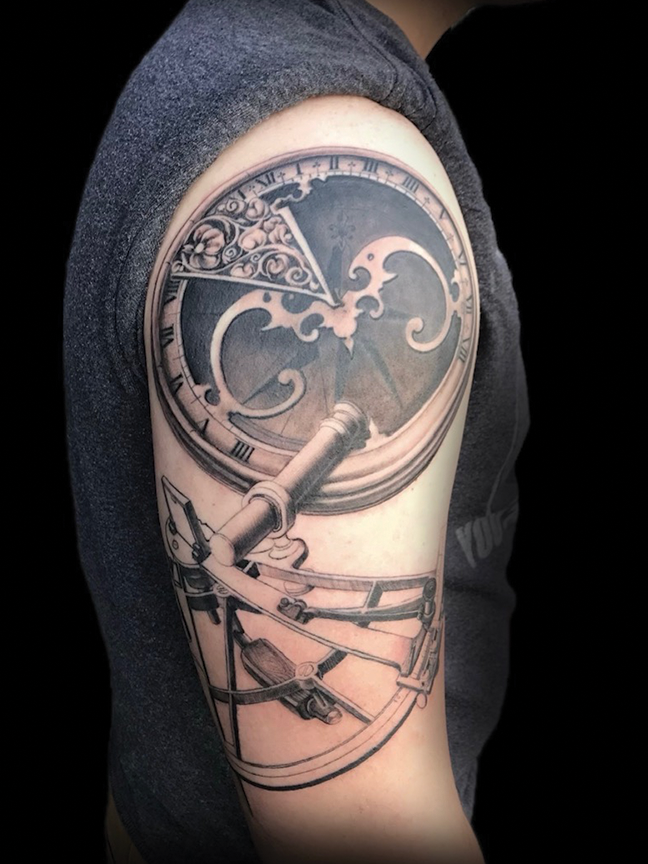 sun dial tattoo on arm