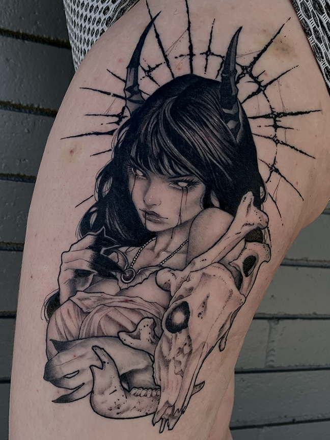 demonized girl and skull tattoo on leg