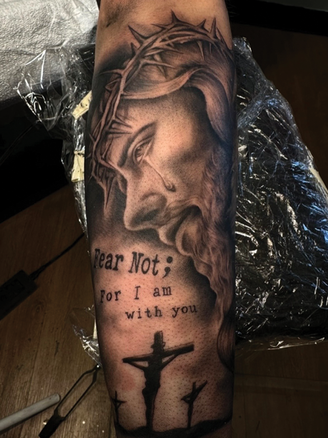 jesus portrait tattoo on arm