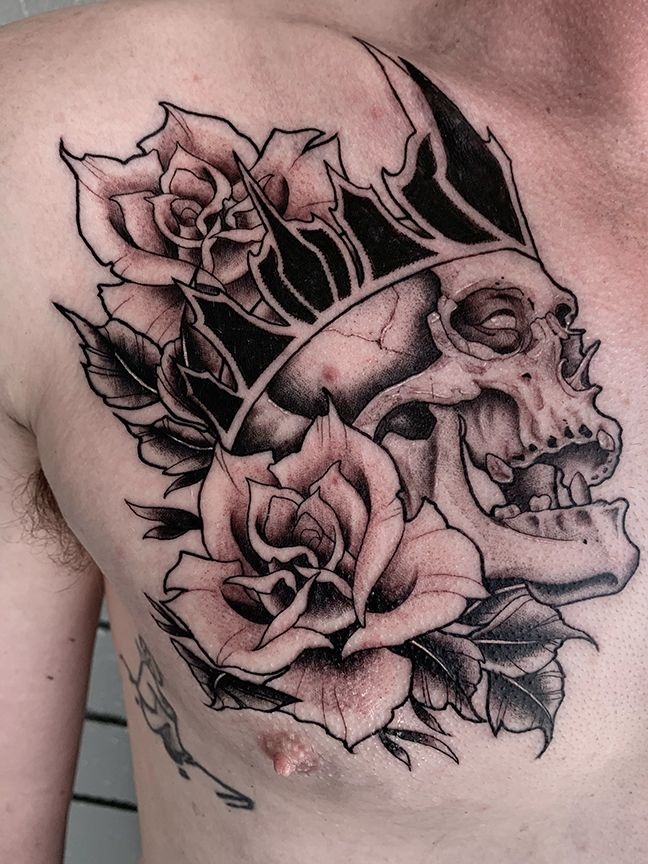 skull and crown tattoo on chest