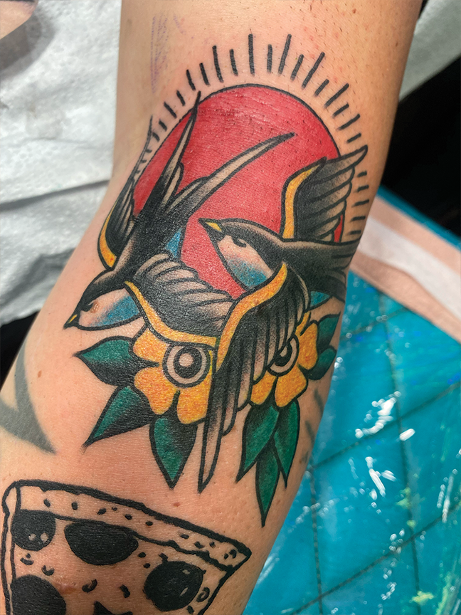 two swallows tattoo on leg