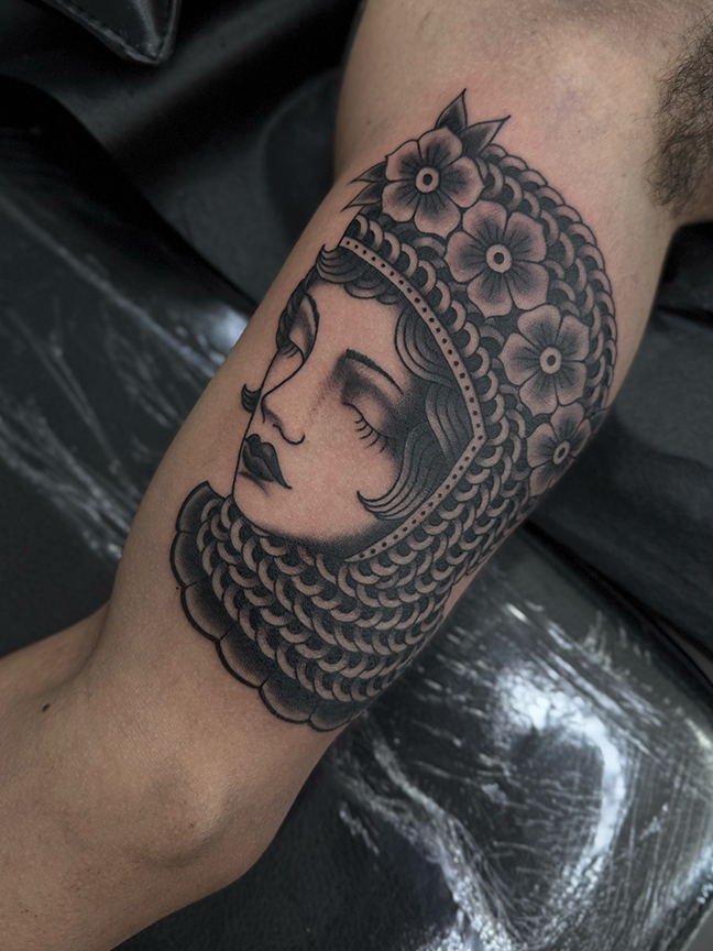 female portrait tattoo on arm